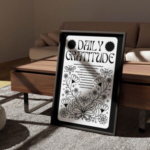 May include: Black and white printable poster with the text "Daily Gratitude" in a bold, decorative font. The poster features a floral design with butterflies and bees, and a list of gratitude prompts.