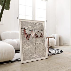 May include: A framed print of a leopard print bikini hanging on a clothesline with the words "NEW YORK" printed on a newspaper background.