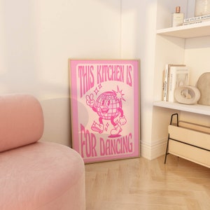 May include: Pink poster with a disco ball character dancing and the text "This kitchen is for dancing".