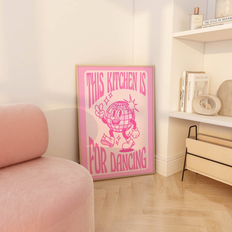 May include: Pink poster with a disco ball character dancing and the text "This kitchen is for dancing".