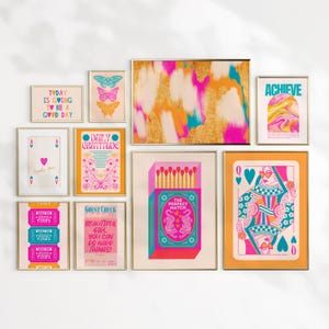 May include: A wall gallery featuring nine framed prints with a retro, colorful aesthetic. The prints include motivational quotes, abstract designs, and illustrations of butterflies, playing cards, and matchsticks.