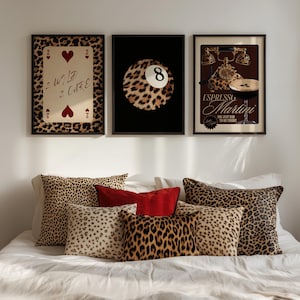 May include: Three framed prints with a leopard print design. The first print features a playing card with the text "2 Wild 2 Care". The second print features a leopard print 8-ball. The third print features a vintage phone with the text "Espresso Martini, You just had to be there!"