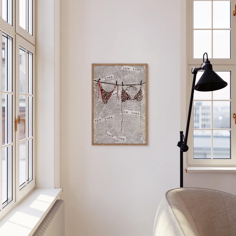 May include: A framed print of a leopard print bikini hanging on a clothesline with the words "New York" printed on a newspaper background.