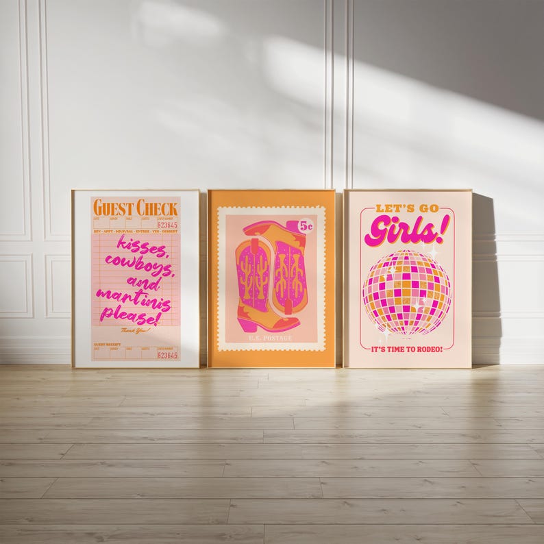 May include: Three framed prints with a retro 70s aesthetic. The first print features a guest check with the text "kisses, cowboys, and martinis please!" The second print features a pair of pink cowboy boots with a cactus design on a peach background. The third print features a pink disco ball with the text "Let's Go Girls! It's Time to Rodeo!"