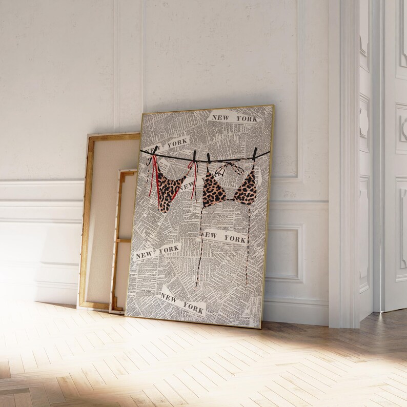 May include: A framed print of a newspaper page with the word "NEW YORK" printed repeatedly. Two leopard print bikinis are hanging on a clothesline with red string.
