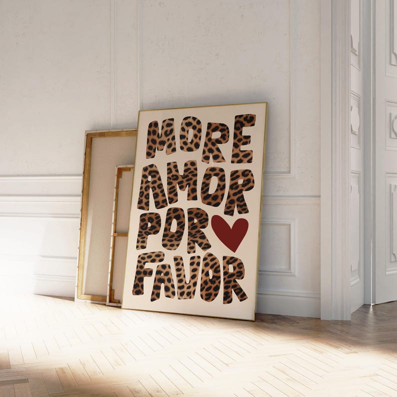 May include: A white canvas print with the text "MORE AMOR POR FAVOR" in brown and black leopard print letters. A red heart is in the middle of the text.