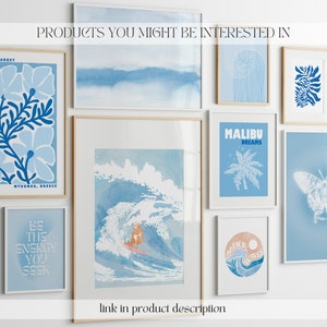 May include: A collection of eight blue and white framed prints with various designs, including a flower market scene, a wave with a surfer, a palm tree, a butterfly, and abstract designs. The prints are arranged on a white wall with the text "PRODUCTS YOU MIGHT BE INTERESTED IN" at the top.