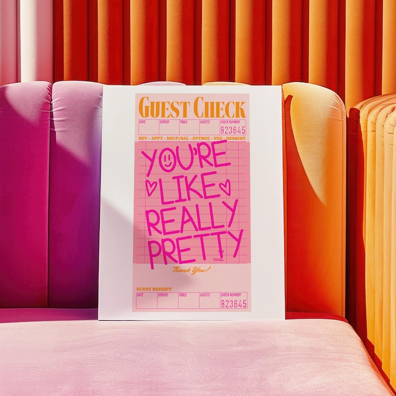 May include: A pink and white guest check with the text "YOU'RE LIKE REALLY PRETTY" written in pink. The check has a grid pattern and the check number is 823645.