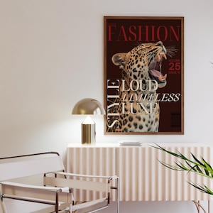 May include: A magazine cover with a leopard roaring with its mouth open. The magazine is titled "The Fashion Style" with the words "Loud, Limitless, Luxe" in white text. The magazine cover is brown with a red border.