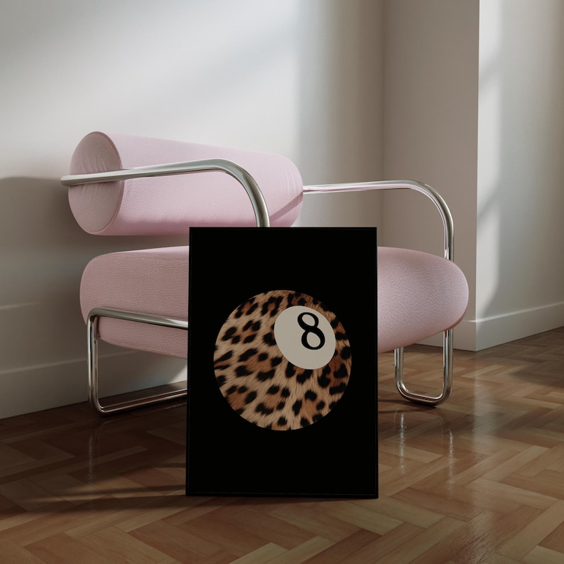May include: A black and white print of a leopard print billiard ball with the number 8 on it. The print is on a black background.