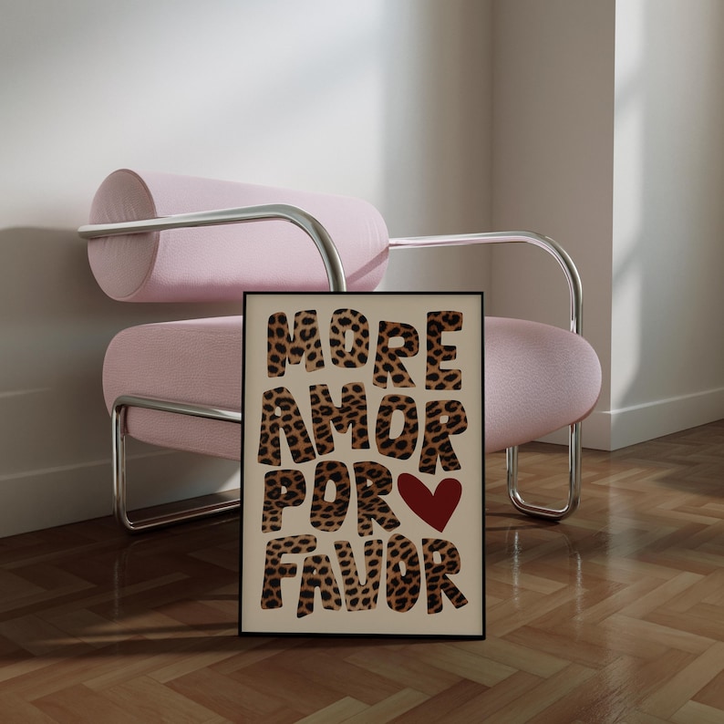 May include: A beige poster with the words "MORE AMOR POR FAVOR" in large, black letters with a leopard print pattern. A red heart is in the middle of the text.