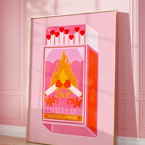 May include: A pink and orange illustration of a matchbox with the text "ONE PERFECT MATCH MADE IN HEAVEN". The matchbox has a red heart on fire with two matchsticks crossed underneath.