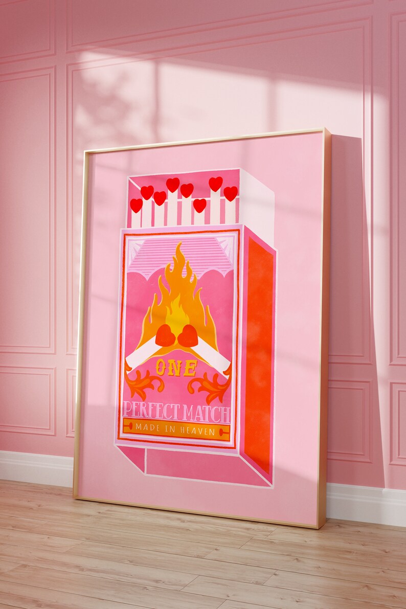May include: A pink and orange illustration of a matchbox with the text "ONE PERFECT MATCH MADE IN HEAVEN". The matchbox has a red heart on fire with two matchsticks crossed underneath.