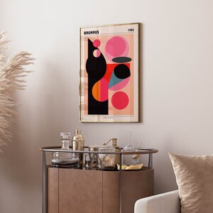 May include: A framed poster featuring a geometric design in black, red, pink, and blue. The poster has the text "BAUHAUS 1923" at the top and "gallery exhibition" at the bottom.