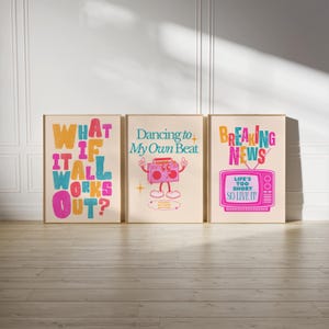 May include: Three framed prints with colorful text and illustrations. The first print says "What if it all works out?" The second print says "Dancing to my own beat" and features a cartoon boombox. The third print says "Breaking News" and features a cartoon television with the text "Life's too short, so live it!"