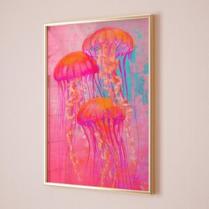 May include: A framed print of three pink and orange jellyfish with long tentacles against a pink and blue background.