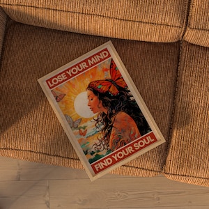 May include: A vintage-style poster with a woman with long dark hair and a butterfly on her head. The poster has a yellow, orange, and red color scheme and the text "Lose Your Mind Find Your Soul".