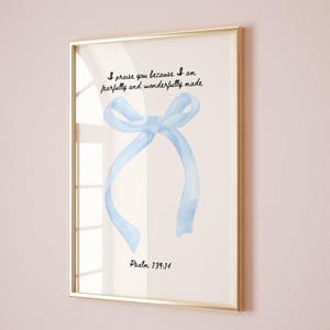 May include: A framed print with a blue watercolor bow and the text "I praise you because I am fearfully and wonderfully made. Psalm 139:14"