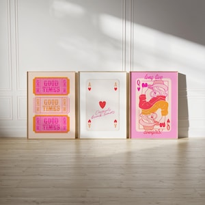 May include: Three framed prints with a pink and orange color scheme. The left print features the text "Good Times" repeated three times. The middle print features a red heart with the text "Cowgirls break hearts". The right print features a pink background with a woman in a cowboy hat and the text "long live cowgirls!"
