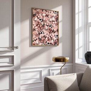 May include: A framed print of a pink and black disco ball pattern. The print is hanging on a white wall in a room with a white door and a couch.