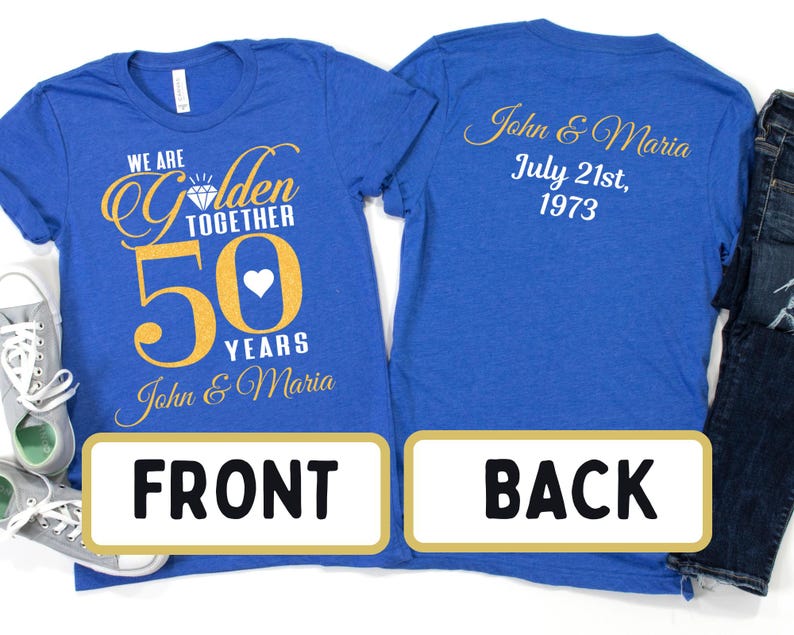 May include: Two royal blue t-shirts with gold text. The front shirt says "We are Golden Together 50 Years John & Maria". The back shirt says "John & Maria July 21st, 1973".