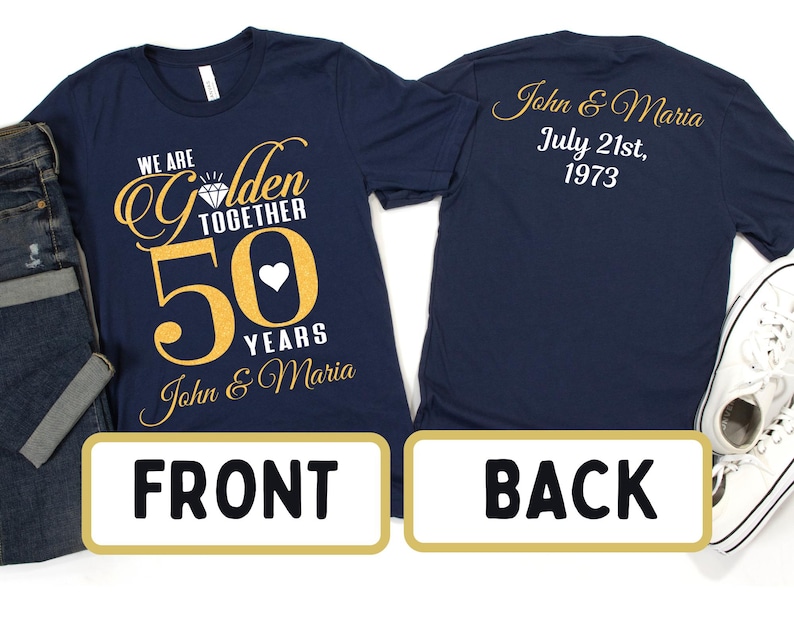 May include: Navy blue t-shirt with gold text that reads "We are Golden Together 50 Years John & Maria". The back of the shirt has gold text that reads "John & Maria July 21st, 1973".