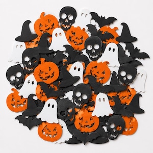 May include: A collection of Halloween-themed confetti pieces in various shapes including orange jack-o'-lanterns, white ghosts, black skulls, black witch hats, and black bats. The assorted cutout shapes are arranged in a circular cluster.