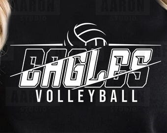 May include: Black garment with a white volleyball graphic. The word "EAGLES" is prominently displayed above "VOLLEYBALL" in a bold, outlined font. A volleyball graphic sits above the word "EAGLES".