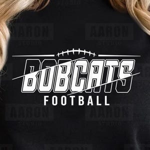 May include: Black and white graphic design with the text "Bobcats Football" on a black t-shirt.