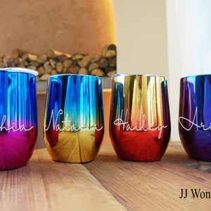 May include: Four iridescent stainless steel tumblers with personalized names: Sophia, Natalia, Hailey, and Ariana. The tumblers have a gradient color effect, with each one featuring a different color combination.