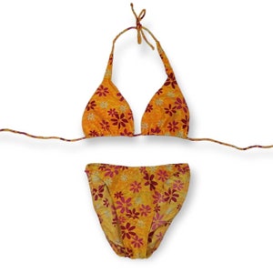 May include: A yellow and pink floral print bikini top and bottom. The top is a triangle style with adjustable straps. The bottom is a high-cut style with a moderate rise.