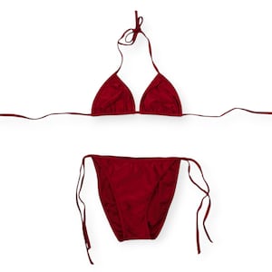 May include: A red bikini set with a triangle top and a tie-side bottom.