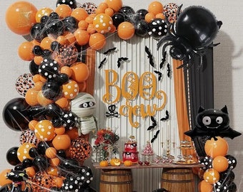 May include: Halloween party decorations with orange and black balloons, a spider, a bat, and a sign that says "Boo Crew".