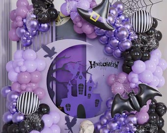 May include: A Halloween-themed balloon arch in shades of purple, black, and white. The display includes a witch's hat, bat, spiderweb, and a haunted house silhouette. The word "Halloween" is displayed in the center.