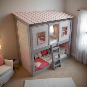 May include: A bunk bed designed like a small house with a light pink roof, gray frame, and white horizontal siding. The structure features two levels, each with a mattress, windows, and a gray ladder attached to the front for access to the top bunk.
