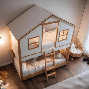 May include: A house-shaped bunk bed with a white roof and walls, and wooden window frames. The bed has a ladder for access to the top bunk. The room is decorated with a hanging light and a teddy bear.