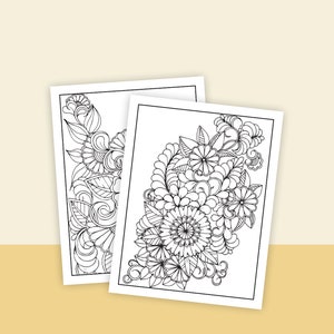 May include: Two black and white printable coloring pages featuring intricate floral designs. The designs include flowers, leaves, and swirls.