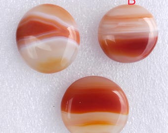 May include: Three round agate cabochons with red and white banding. The cabochons are labeled A, B, and C.