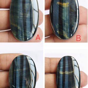 May include: Four oval-shaped blue tiger's eye gemstones with a golden sheen. The stones are labeled A, B, C, and D.