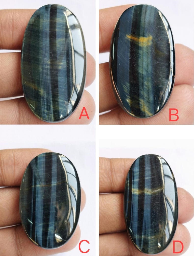 May include: Four oval-shaped blue tiger's eye gemstones with a golden sheen. The stones are labeled A, B, C, and D.