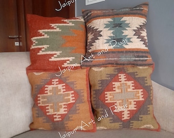 May include: Four decorative throw pillows with geometric patterns in shades of brown, orange, and green. The pillows are arranged on a light gray couch.