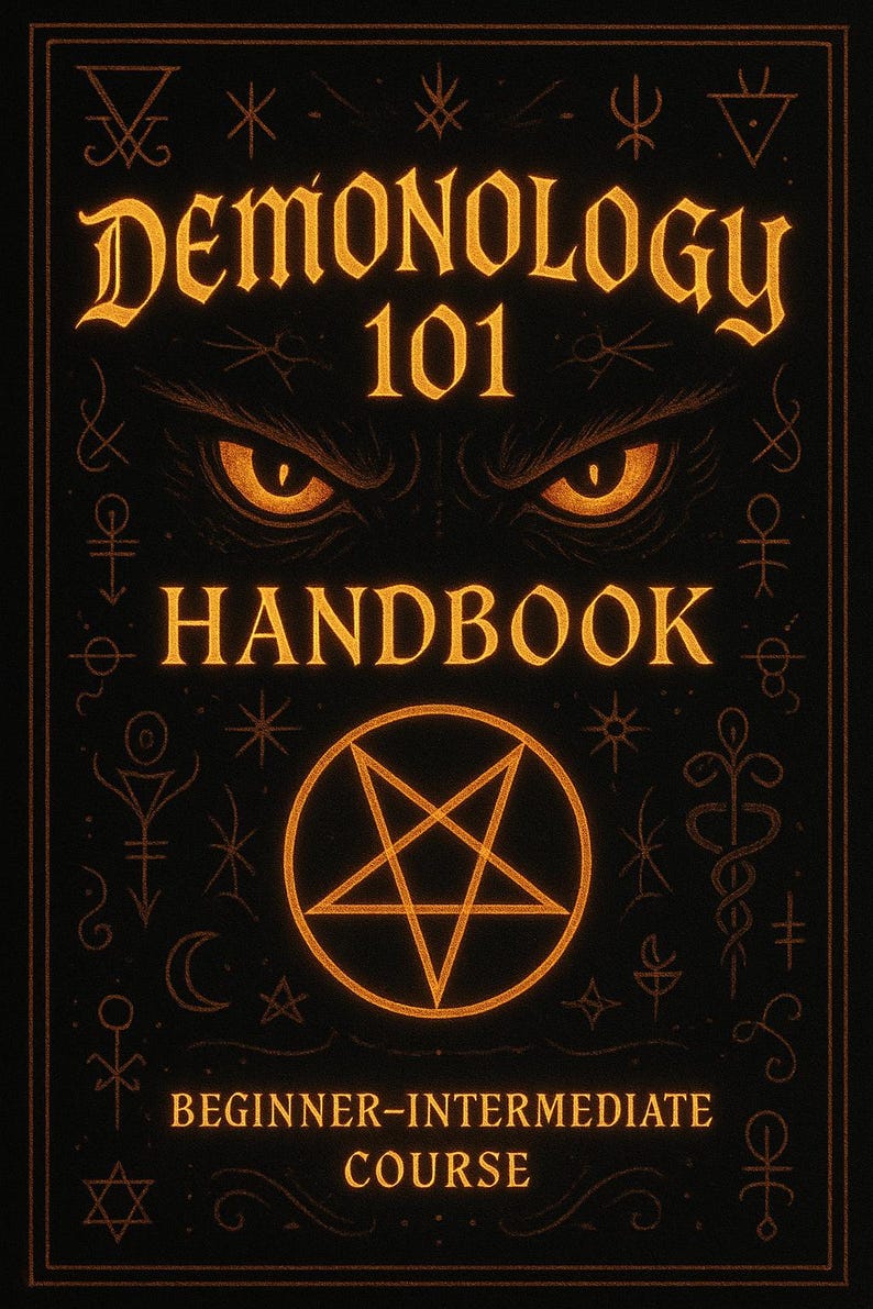 May include: A black handbook titled "Demonology 101 Handbook" with gold lettering and a pentagram. The cover features glowing orange eyes and decorative symbols. The text reads "Beginner-Intermediate Course".
