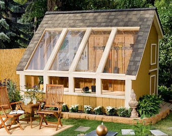 May include: A yellow wooden shed with a glass roof and windows. The shed has a small door and a wooden shelf inside. There are plants and flowers growing around the shed.