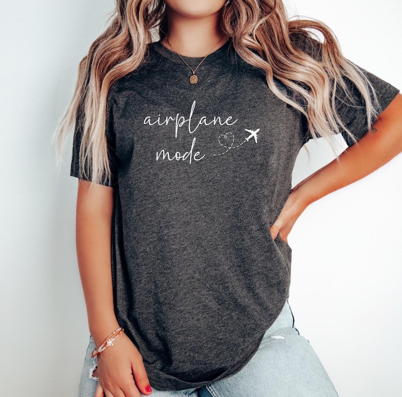 travel lover t shirt that says airplane mode andhas a plane flying with a heart behind it made of exhaust fromtheplane perfect for travelers