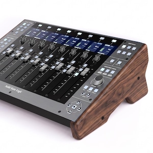 May include: A Solid State Logic audio mixing console featuring a dark gray control surface with multiple faders, rotary knobs, and digital displays, encased in polished dark brown wood side panels with a distinct grain pattern and black screws.