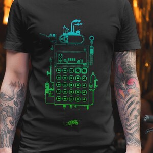 May include: Black t-shirt with a green and blue graphic of a robot made of gears, pipes, and other mechanical parts.
