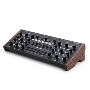 May include: A black desktop synthesizer with wooden side panels, featuring numerous black and silver rotary knobs, white push buttons, and printed labels. The device includes the text ECHONG and M A Morphor on the top surface.