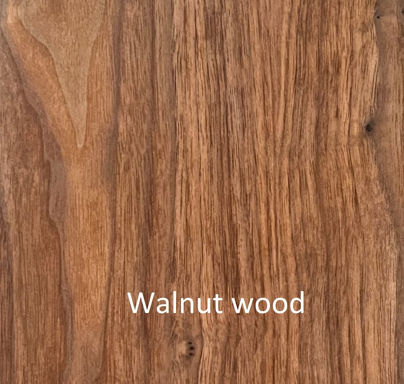 May include: Close-up of walnut wood grain. The wood has a warm brown color with vertical lines and natural patterns. The text "Walnut wood" is displayed in white at the bottom of the image.
