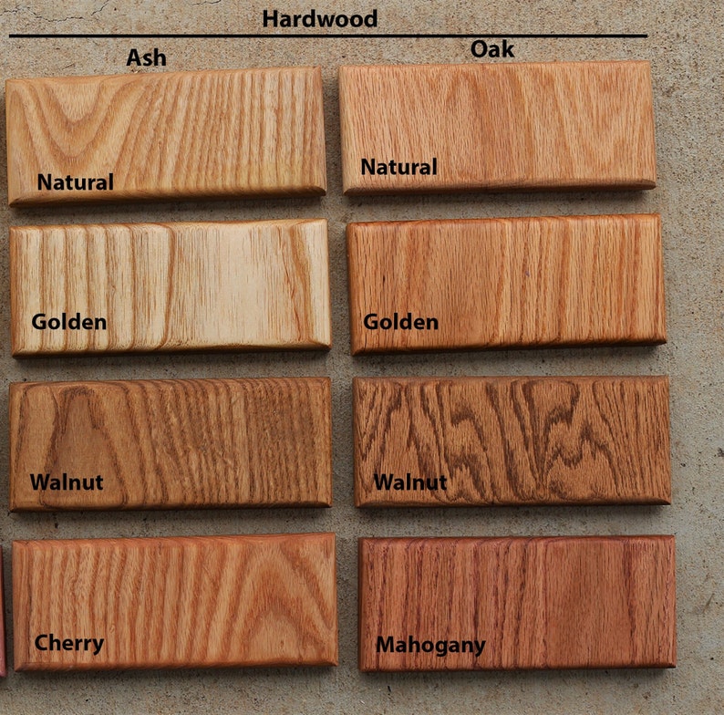 May include: A collection of hardwood samples, including Ash and Oak, with various finishes. The samples are labeled with the wood type and finish, such as "Natural," "Golden," "Walnut," "Cherry," and "Mahogany." The samples are rectangular and display the wood grain.