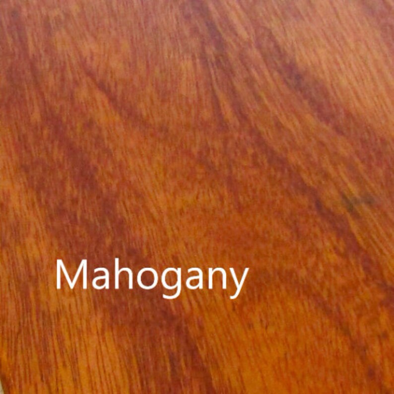 May include: Close-up of a mahogany wood grain pattern. The wood has a reddish-brown color with darker streaks and a smooth, polished appearance. The word "Mahogany" is displayed in white text.